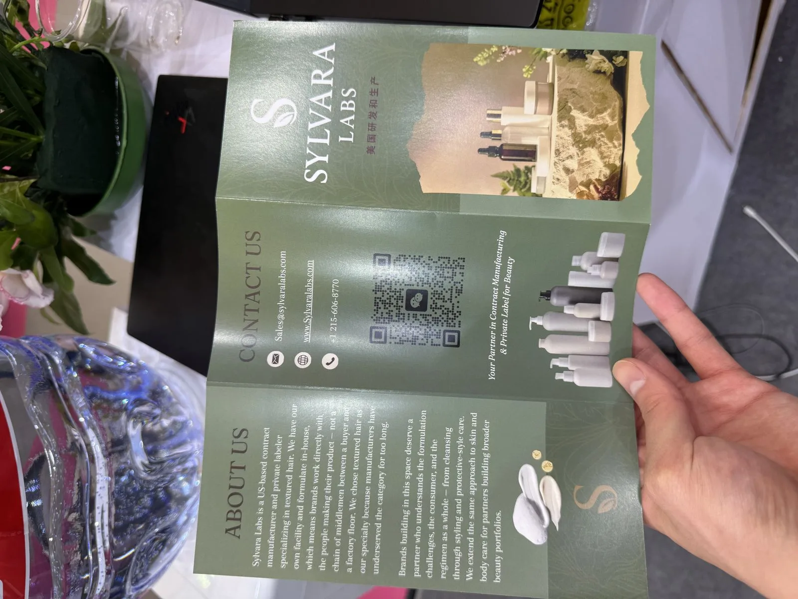 Sylvara Labs brochure open in hand — about us and contact spread